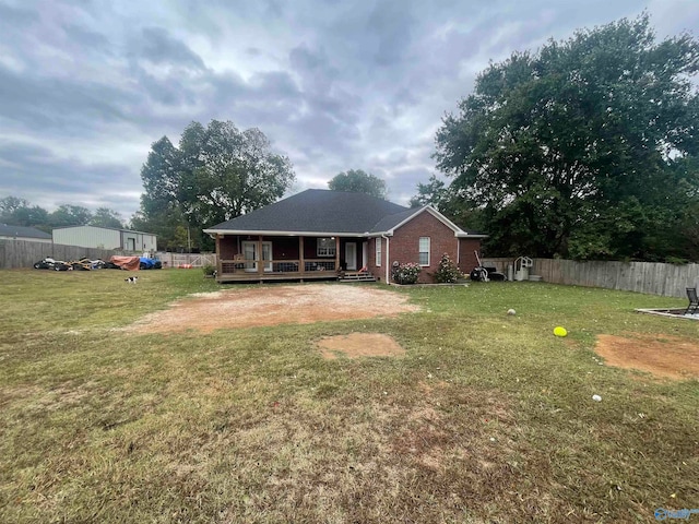 rear view of property with a yard