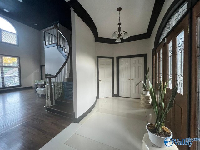 entrance foyer featuring wood-type flooring and an inviting chandelier