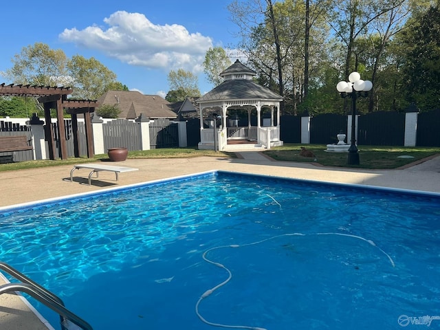 view of swimming pool with a gazebo, a diving board, and a patio