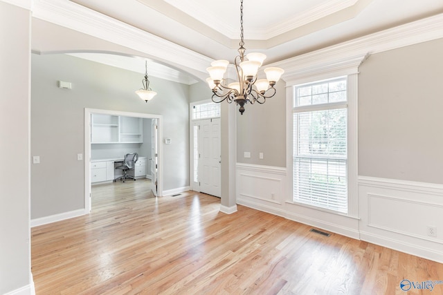 238 Riverwalk Trl, New Market, AL 35716 - unfurnished dining area featuring healthy amount of natural light, light wood-style flooring, a desk, arched walkways, and crown molding