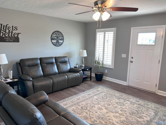 living room with hardwood / wood-style flooring, a textured ceiling, a wealth of natural light, and ceiling fan