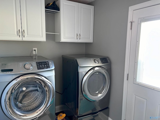 clothes washing area featuring plenty of natural light, cabinets, and independent washer and dryer