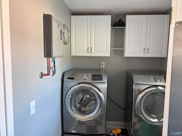 laundry room with cabinets and washer and dryer