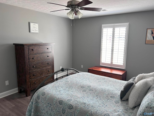 bedroom featuring ceiling fan, a textured ceiling, and hardwood / wood-style floors