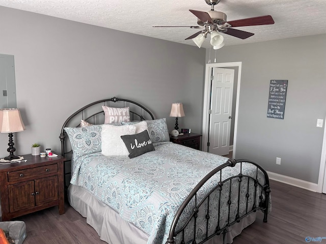 bedroom with hardwood / wood-style floors, ceiling fan, and a textured ceiling