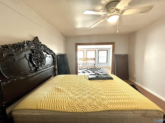 bedroom with baseboards and a ceiling fan