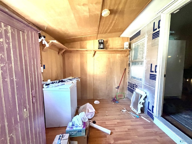 laundry area featuring laundry area, wooden walls, wood ceiling, washer / clothes dryer, and wood finished floors