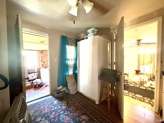 interior space with washer / dryer, wood finished floors, and a ceiling fan