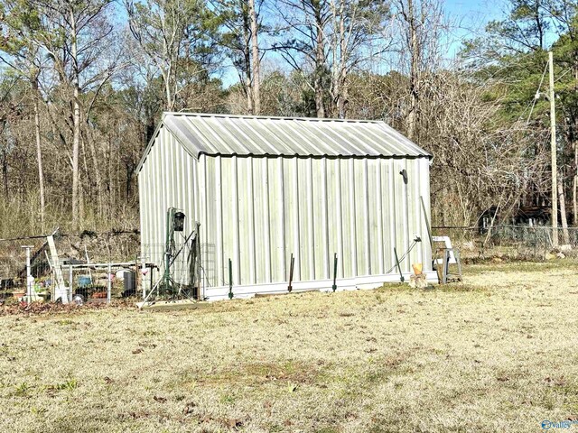 view of shed featuring fence