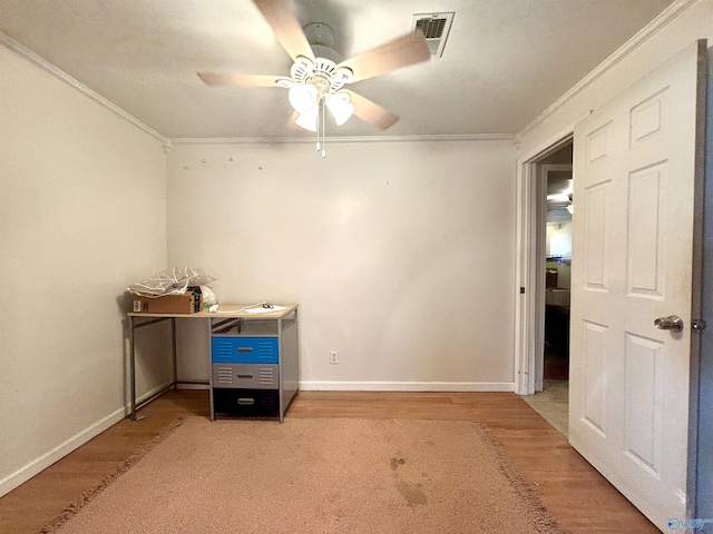 interior space with light wood finished floors, visible vents, baseboards, a ceiling fan, and ornamental molding