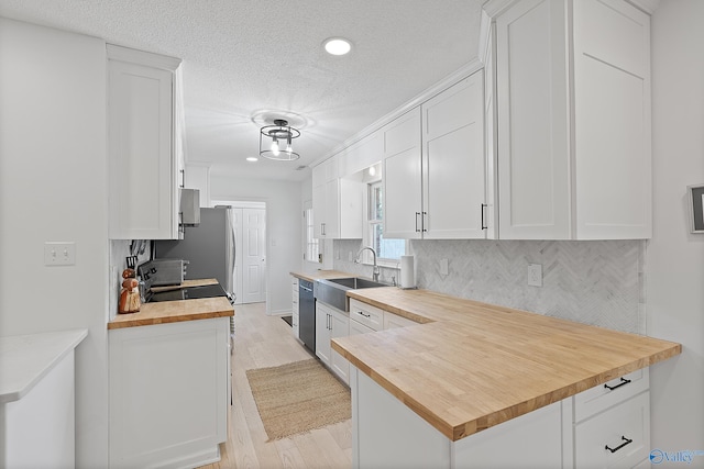 24961 Capshaw Rd, Athens, AL 35613 - kitchen featuring butcher block counters, dishwasher, white cabinets, recessed lighting, and a textured ceiling