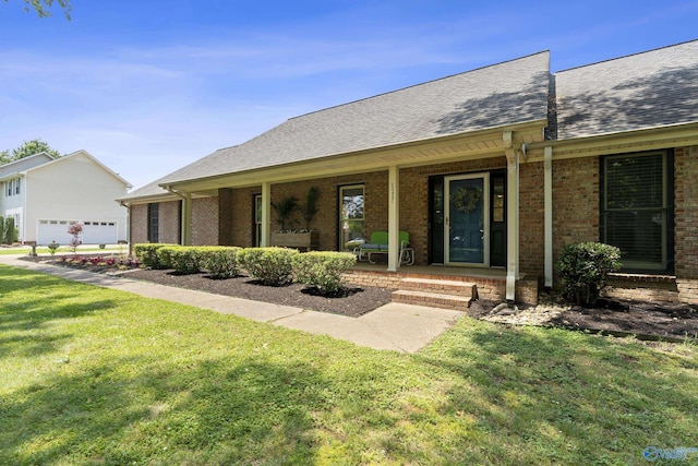 24961 Capshaw Rd, Athens, AL 35613 - single story home featuring a front yard, brick siding, covered porch, and a shingled roof
