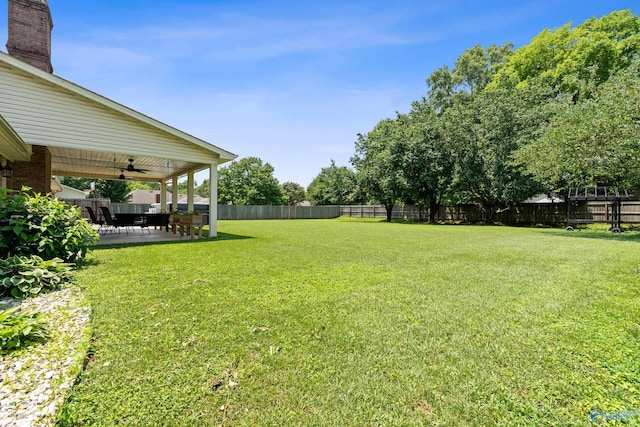 24961 Capshaw Rd, Athens, AL 35613 - fenced backyard featuring a ceiling fan and a patio