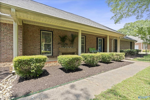 24961 Capshaw Rd, Athens, AL 35613 - entrance to property with covered porch, brick siding, and roof with shingles