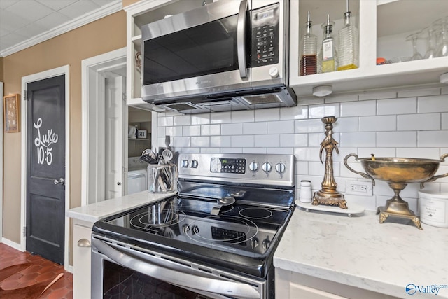 kitchen featuring backsplash, crown molding, appliances with stainless steel finishes, and light stone counters