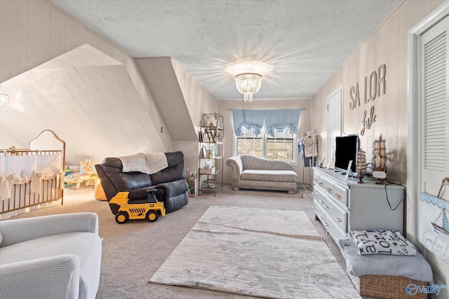 carpeted living area featuring an inviting chandelier