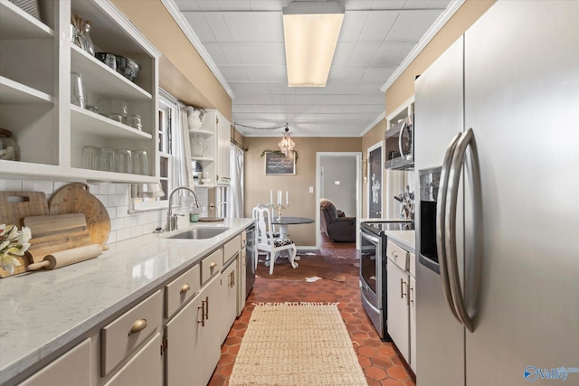 kitchen featuring crown molding, open shelves, decorative backsplash, a sink, and appliances with stainless steel finishes