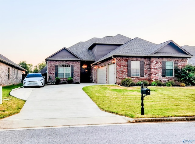 view of front facade with a garage and a yard