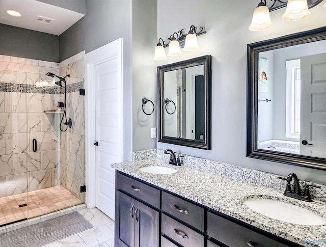 bathroom featuring vanity and a shower with door