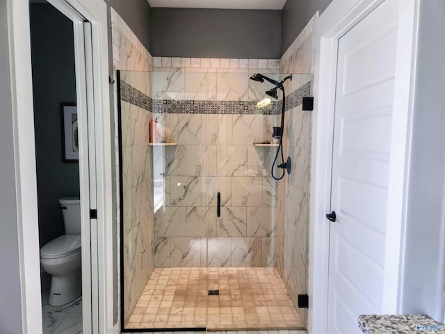 bathroom featuring an enclosed shower and toilet