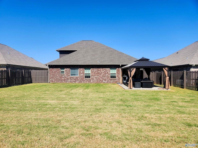 back of house featuring a patio, a yard, and a gazebo