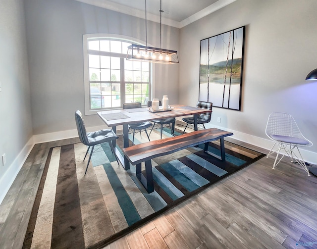 dining room featuring dark hardwood / wood-style floors and ornamental molding