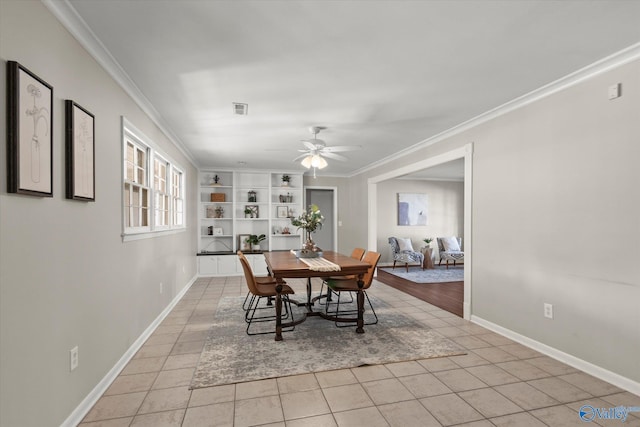 tiled dining space featuring crown molding and ceiling fan