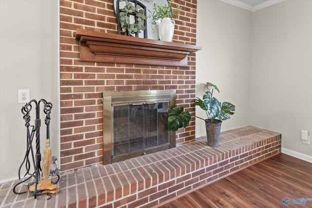 room details featuring a fireplace, wood-type flooring, and ornamental molding