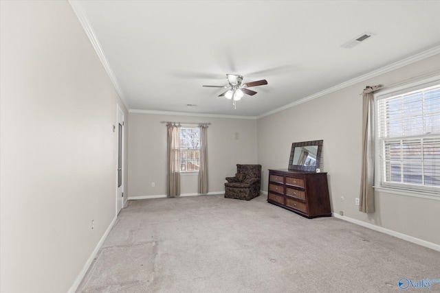 sitting room with ceiling fan, light colored carpet, and ornamental molding