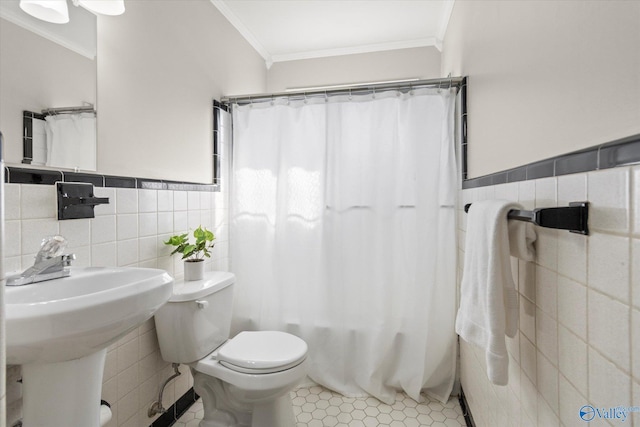 bathroom featuring sink, crown molding, tile walls, tile patterned floors, and toilet