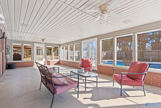 sunroom / solarium featuring ceiling fan