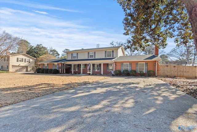 front facade featuring a garage and covered porch