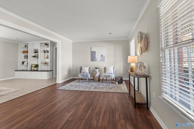 living area with built in shelves, ornamental molding, and wood-type flooring