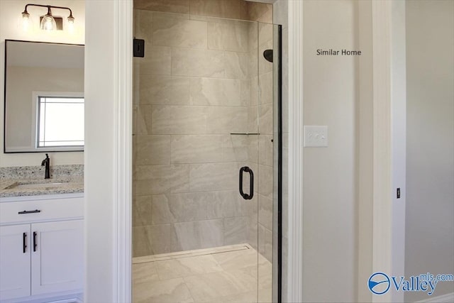 bathroom featuring vanity and a shower with shower door