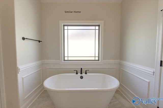 bathroom featuring tile patterned flooring and a tub