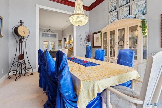 dining space with ornamental molding, a chandelier, carpet flooring, and baseboards