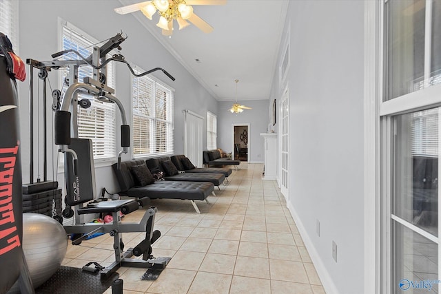 exercise area featuring ceiling fan, ornamental molding, light tile patterned flooring, and a healthy amount of sunlight