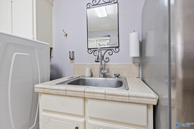 bathroom with ornamental molding and vanity