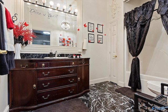 full bath featuring marble finish floor, washtub / shower combination, baseboards, and vanity