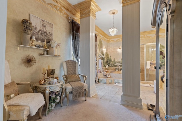 sitting room with decorative columns, ornamental molding, tile patterned flooring, carpet flooring, and a chandelier
