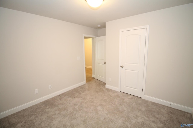 unfurnished bedroom with light colored carpet