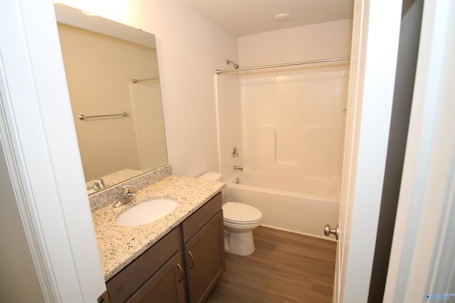 full bathroom with shower / bathing tub combination, wood-type flooring, vanity, and toilet