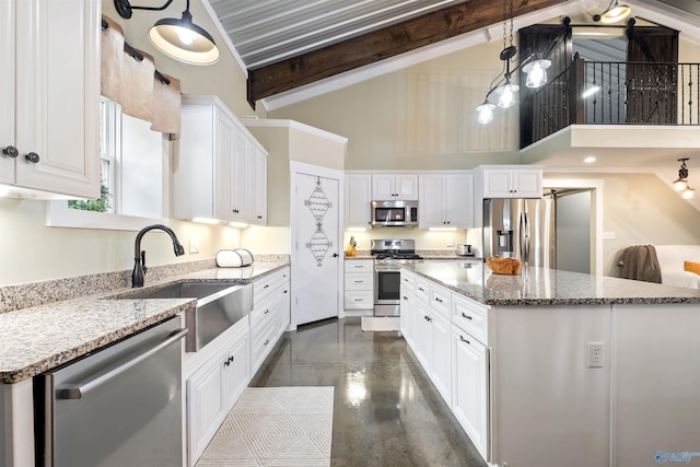 kitchen featuring decorative light fixtures, white cabinetry, and stainless steel appliances