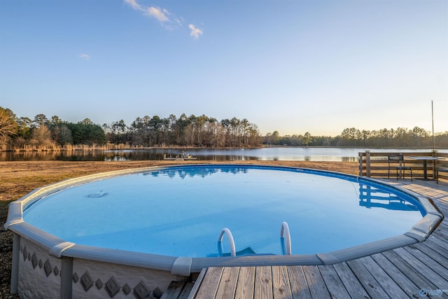 view of pool with a deck with water view