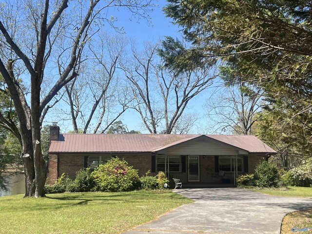 765 County Road 745, Cedar Bluff, AL 35959 - single story home with concrete driveway, a front lawn, brick siding, and metal roof