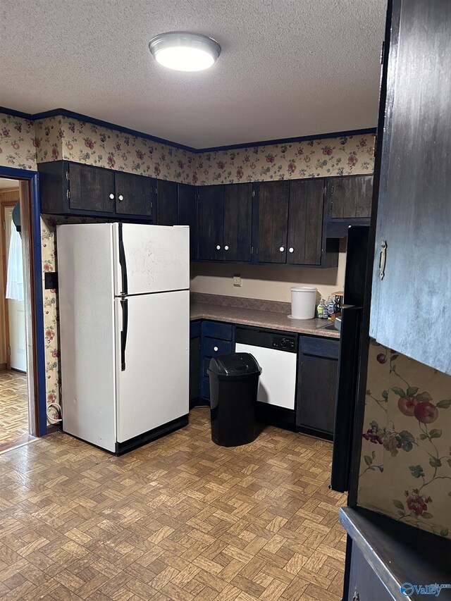 765 County Road 745, Cedar Bluff, AL 35959 - kitchen with light floors, wallpapered walls, a textured ceiling, and white appliances
