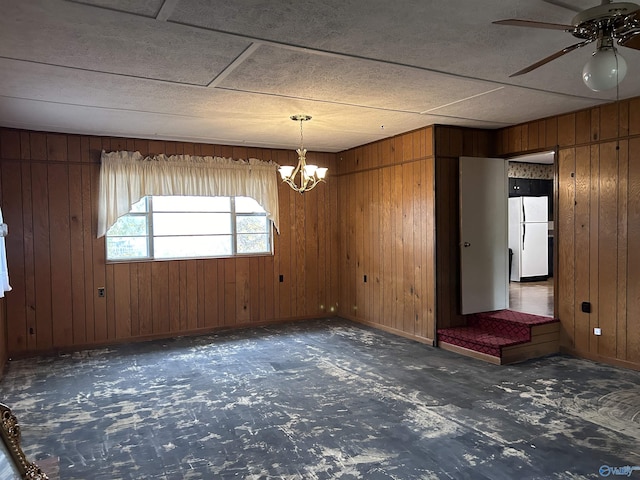 765 County Road 745, Cedar Bluff, AL 35959 - empty room with baseboards, wood walls, and ceiling fan with notable chandelier