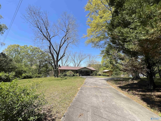 765 County Road 745, Cedar Bluff, AL 35959 - ranch-style house with driveway, a chimney, and a front yard