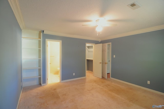 unfurnished bedroom featuring ornamental molding, ensuite bathroom, and ceiling fan