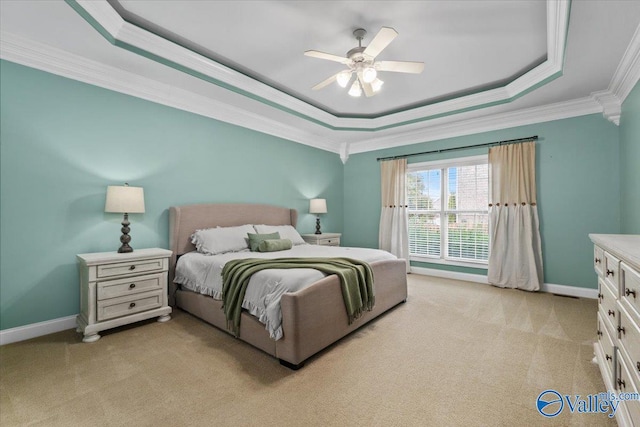 carpeted bedroom featuring ornamental molding, ceiling fan, and a raised ceiling